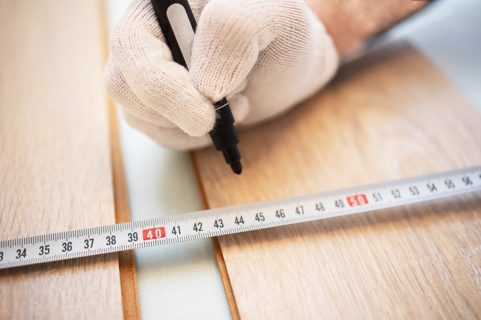 Repairs. Laying laminate flooring. Measuring tape